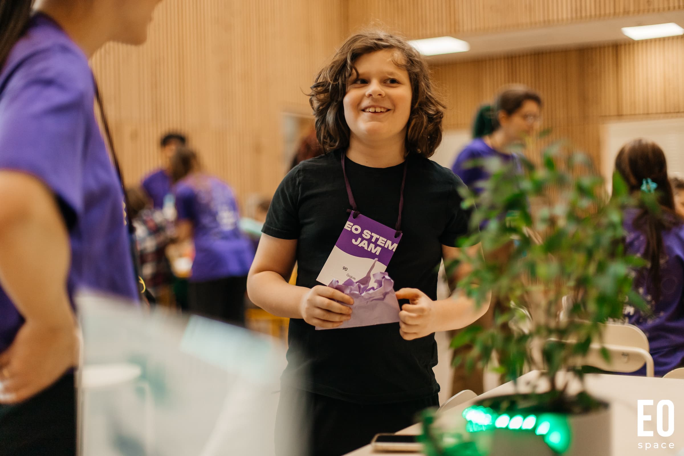 Child at EO STEM Jam wearing an event badge